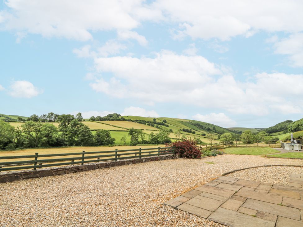 An outdoor area with a stone patio and gravel near fields at Waun Yscir, Merthyr Cynog near Brecon