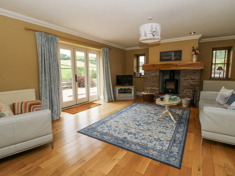 A living room with a fireplace and sofa at Waun Yscir near Brecon