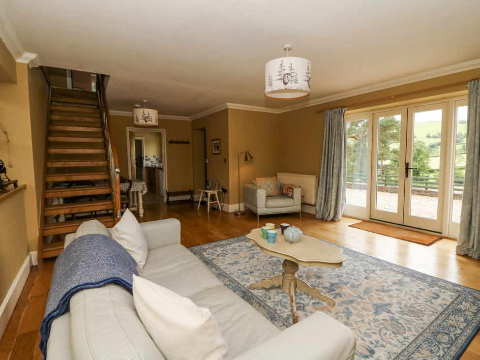 A living room with a staircase and seating area at Waun Yscir near Brecon