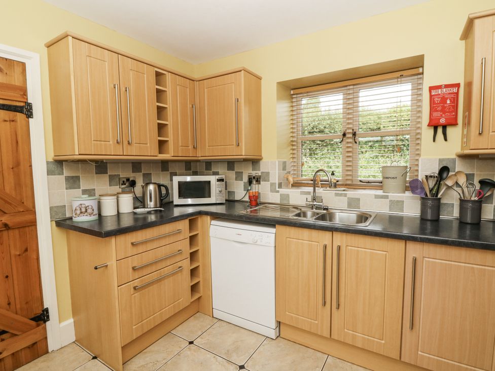 A kitchen with cupboards and appliances at Waun Yscir in Merthyr Cynog near Brecon