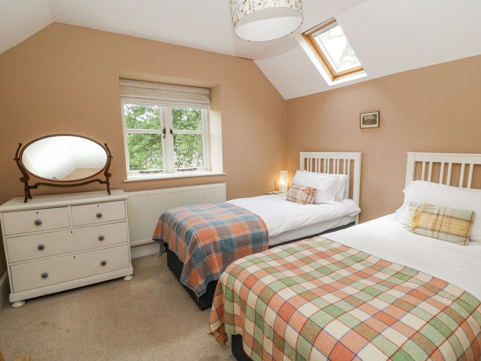 A bedroom with two beds and a dresser at Waun Yscir Merthyr Cynog near Brecon
