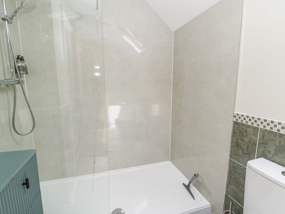 A bathroom with a shower and bathtub at Waun Yscir in Merthyr Cynog near Brecon