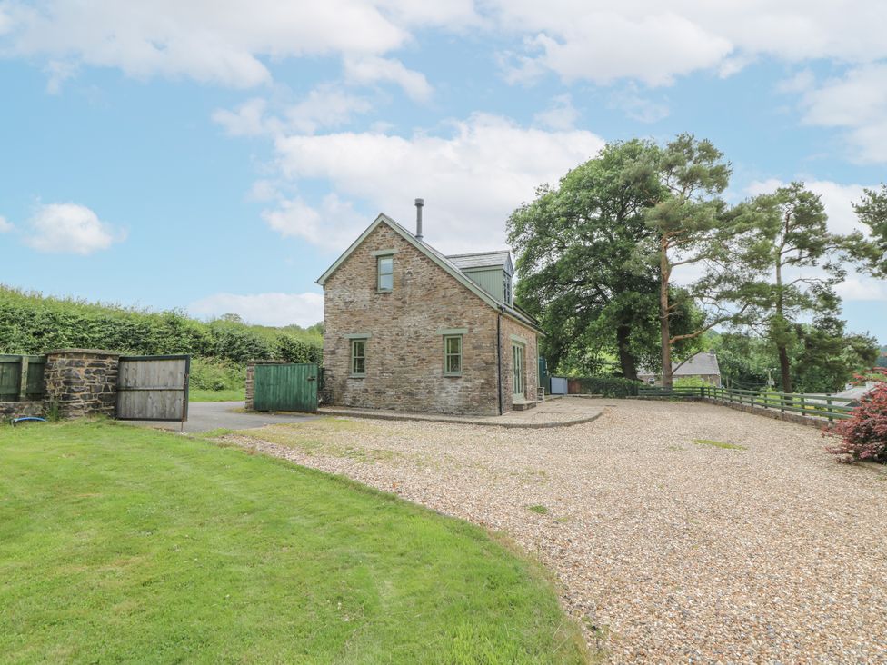 A stone house with a gravel driveway at Waun Yscir Merthyr Cynog near Brecon