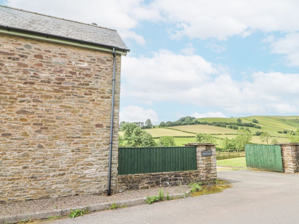 A stone wall with a green gate and fields at Waun Yscir, Merthyr Cynog near Brecon