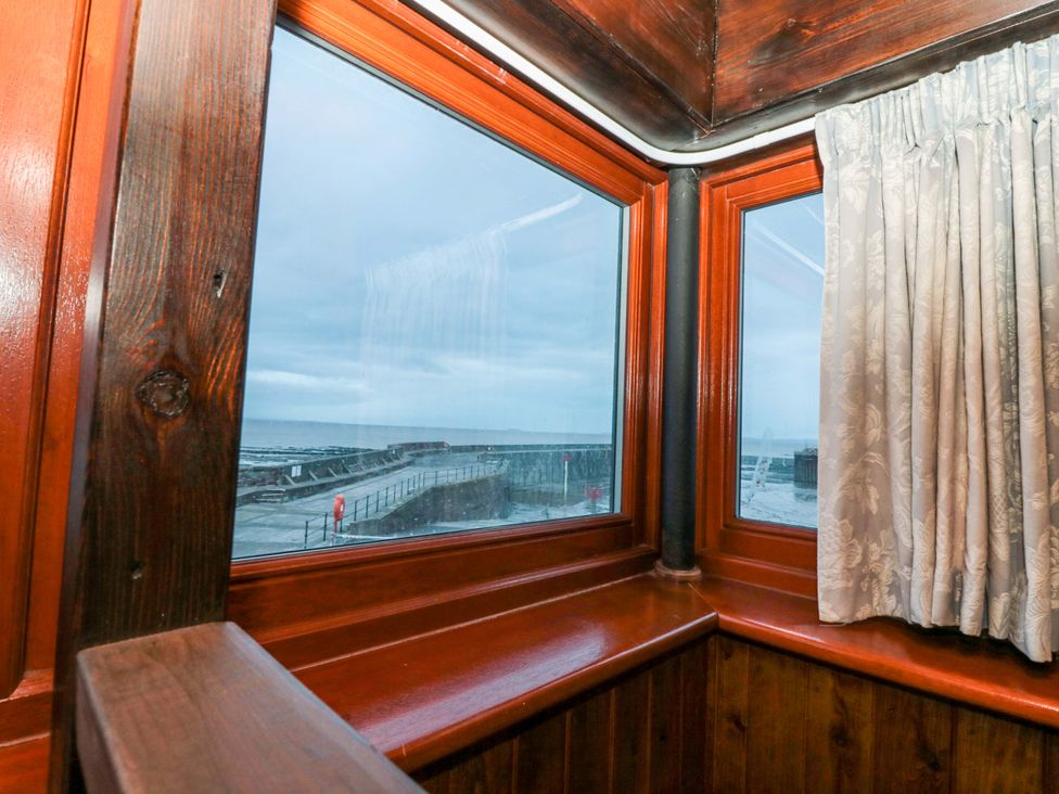 An observation area with windows overlooking the sea at Sammy Hakes Cottage
