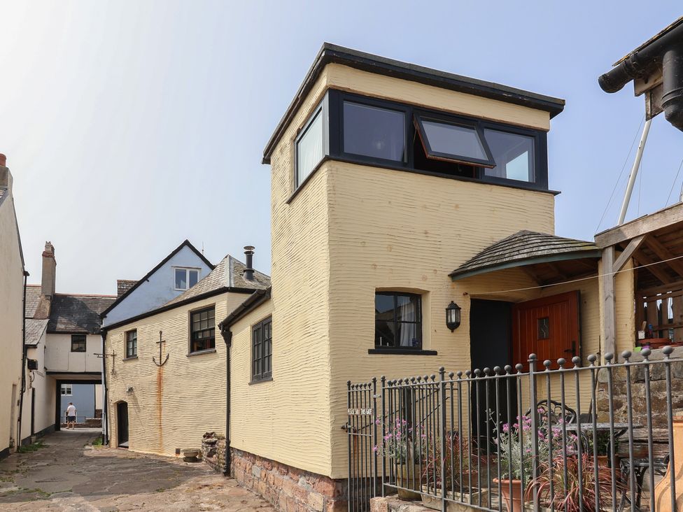 An exterior view of a house with a door and fence at Sammy Hakes Cottage in Watchet
