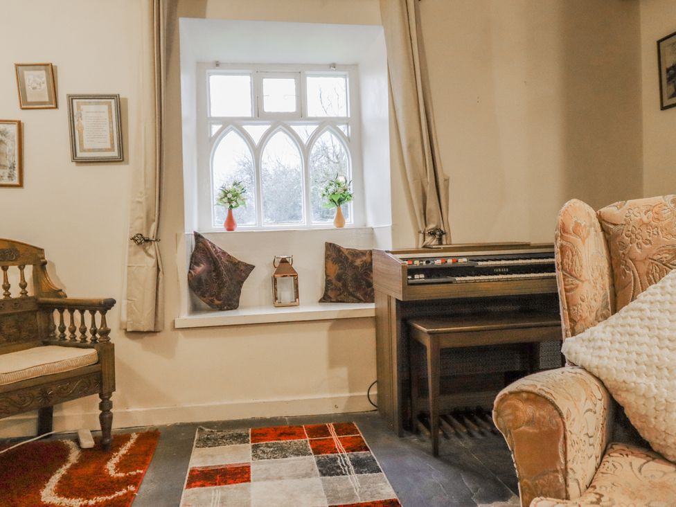 A living room with a window and organ at Cynfal Fawr Near Blaenau Ffestiniog