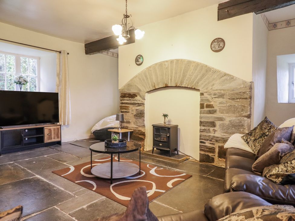 A living room with a television and sofa at Cynfal Fawr near Blaenau Ffestiniog