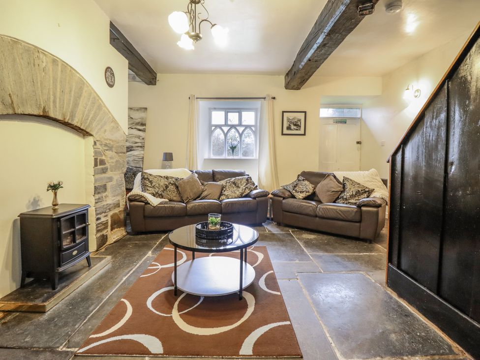 A living room with sofas and a coffee table at Cynfal Fawr near Blaenau Ffestiniog