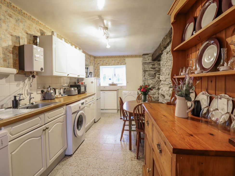 A kitchen with appliances and a table at Cynfal Fawr Near Blaenau Ffestiniog
