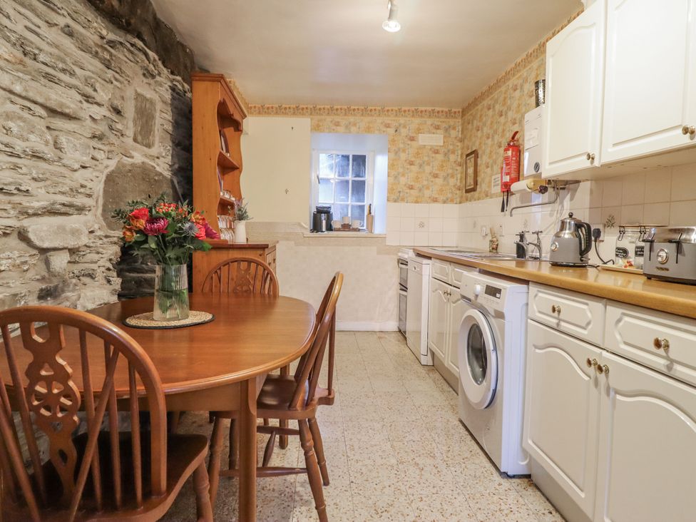 A kitchen with a table and chairs at Cynfal Fawr near Blaenau Ffestiniog