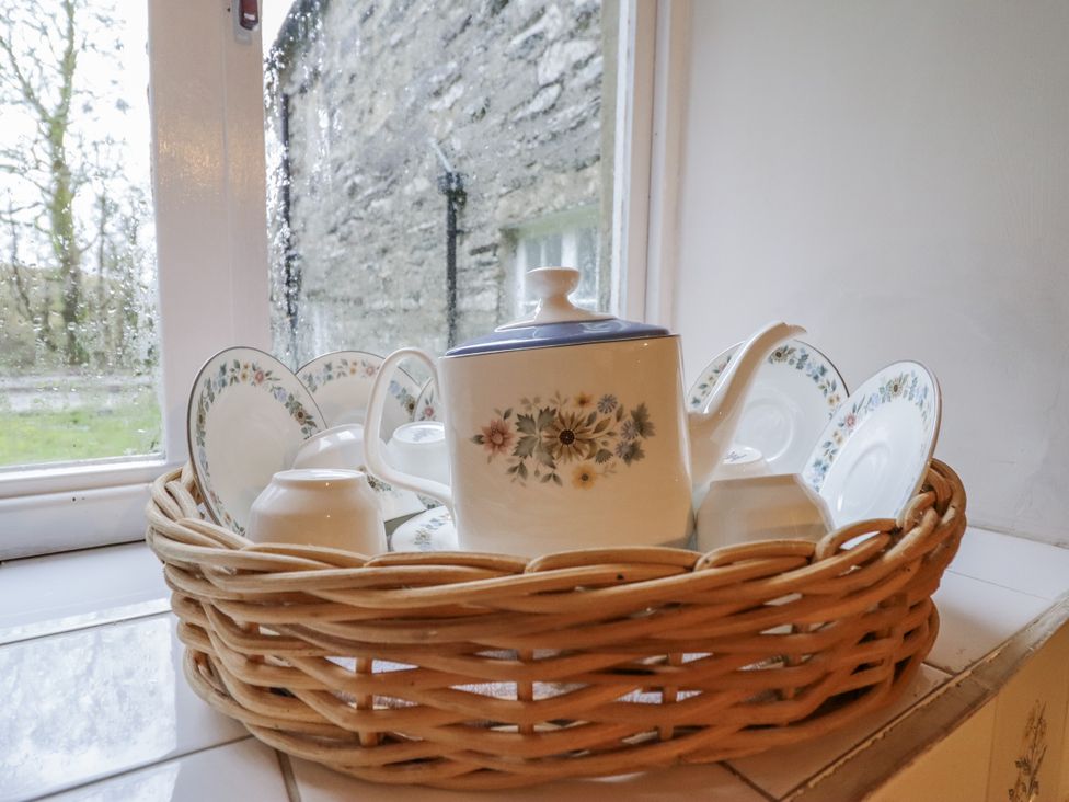 A tea set in a basket on a windowsill at Cynfal Fawr Near Blaenau Ffestiniog