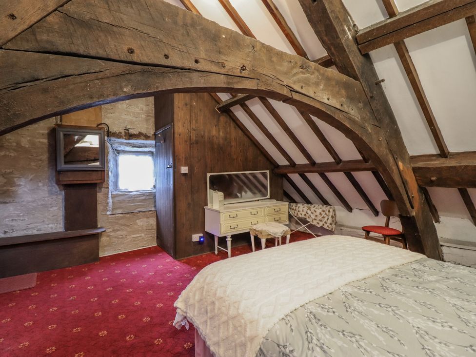 A bedroom with a bed and dresser at Cynfal Fawr Near Blaenau Ffestiniog