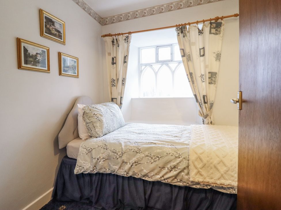 A bedroom with a bed and window at Cynfal Fawr near Blaenau Ffestiniog
