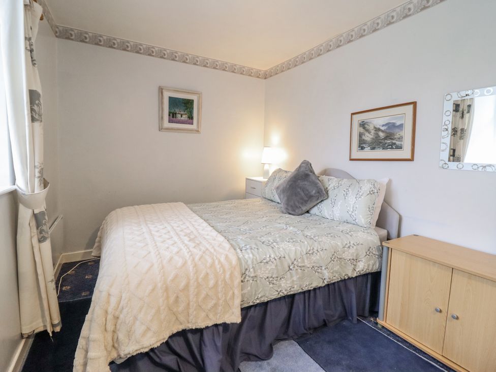 A bedroom with a bed and a lamp at Cynfal Fawr Near Blaenau Ffestiniog