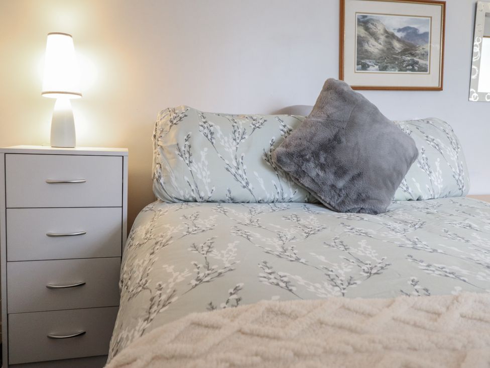 A bedroom with a bed and nightstand at Cynfal Fawr near Blaenau Ffestiniog
