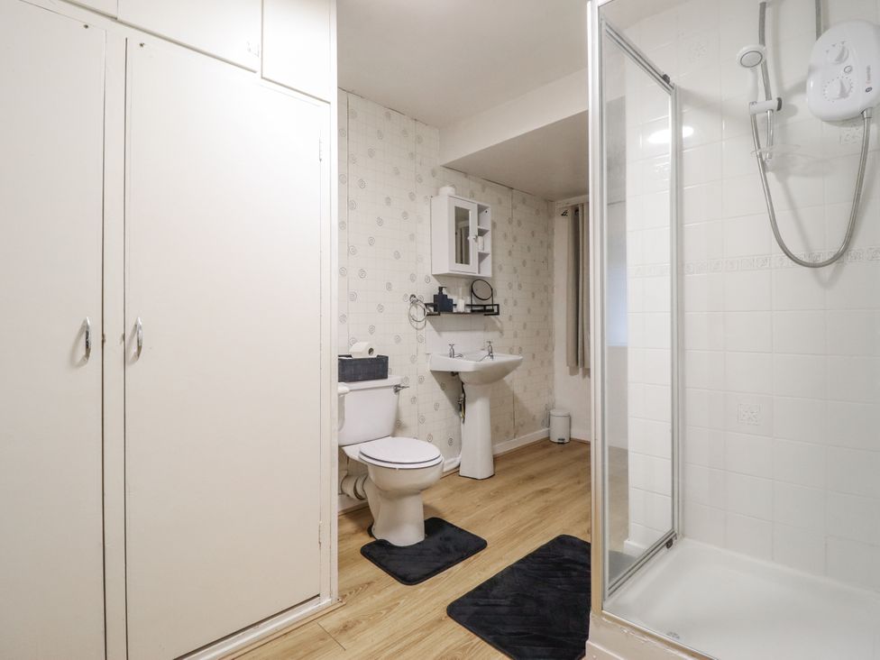 A bathroom with a shower, toilet, and sink at Cynfal Fawr Near Blaenau Ffestiniog