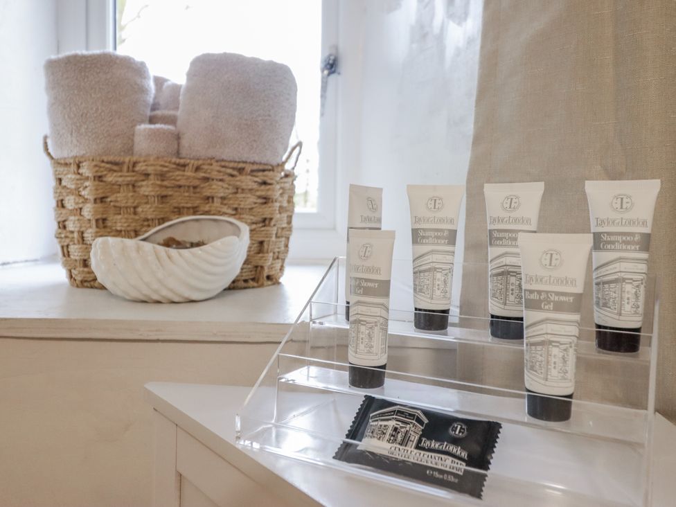 A bathroom display with towels, toiletries, and a decorative shell at Cynfal Fawr Near Blaenau Ffestiniog