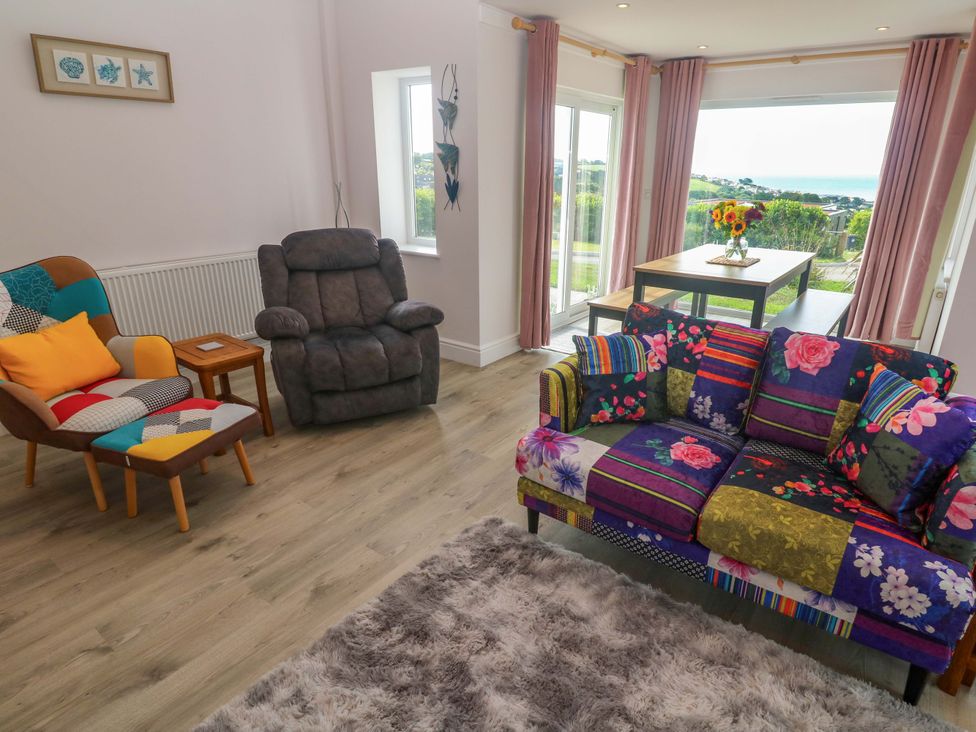 A living room with a colorful sofa and armchair at St Marys in Penzance