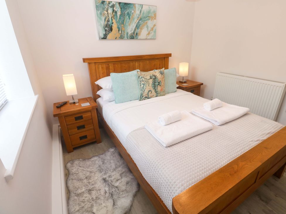 A bedroom with a bed and bedside tables at St Marys in Penzance