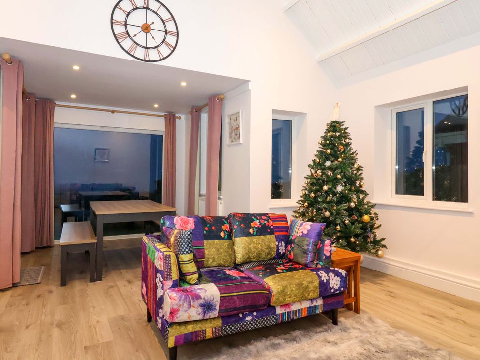 A living room with a sofa and a Christmas tree at St Marys in Praa Sands