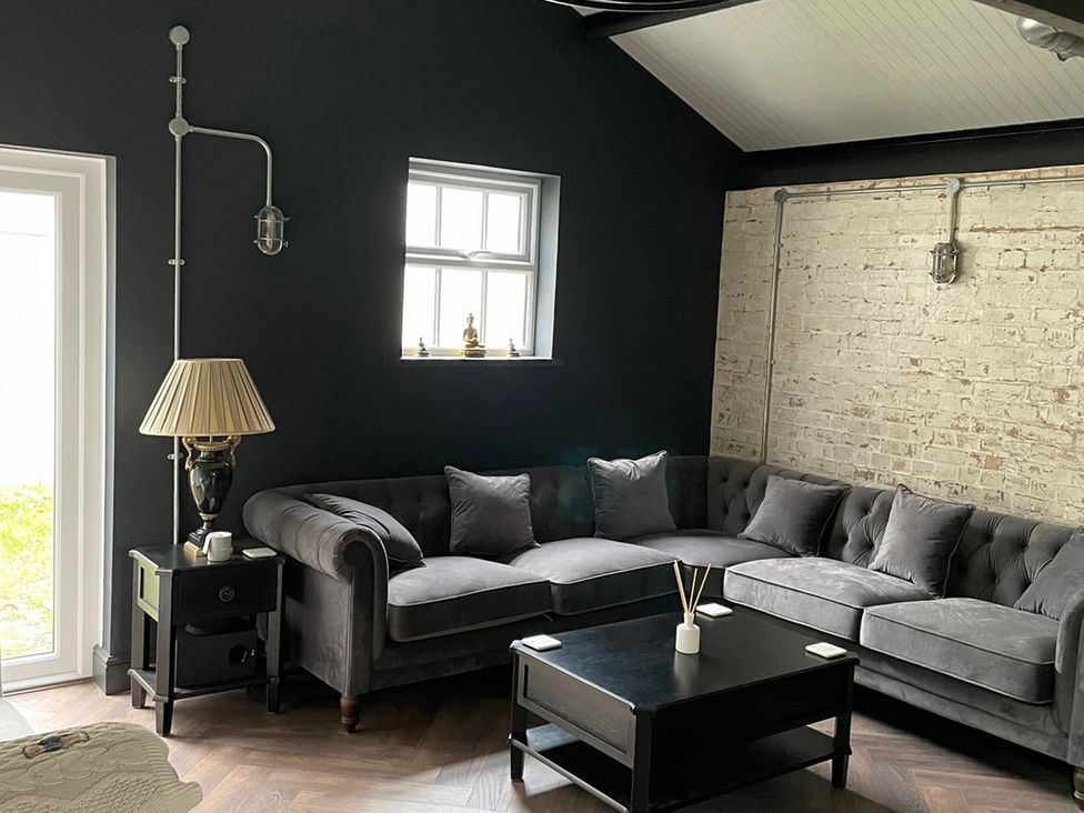 A living room with a sofa and coffee table at The Old Workshop in Wormshill near Harrietsham