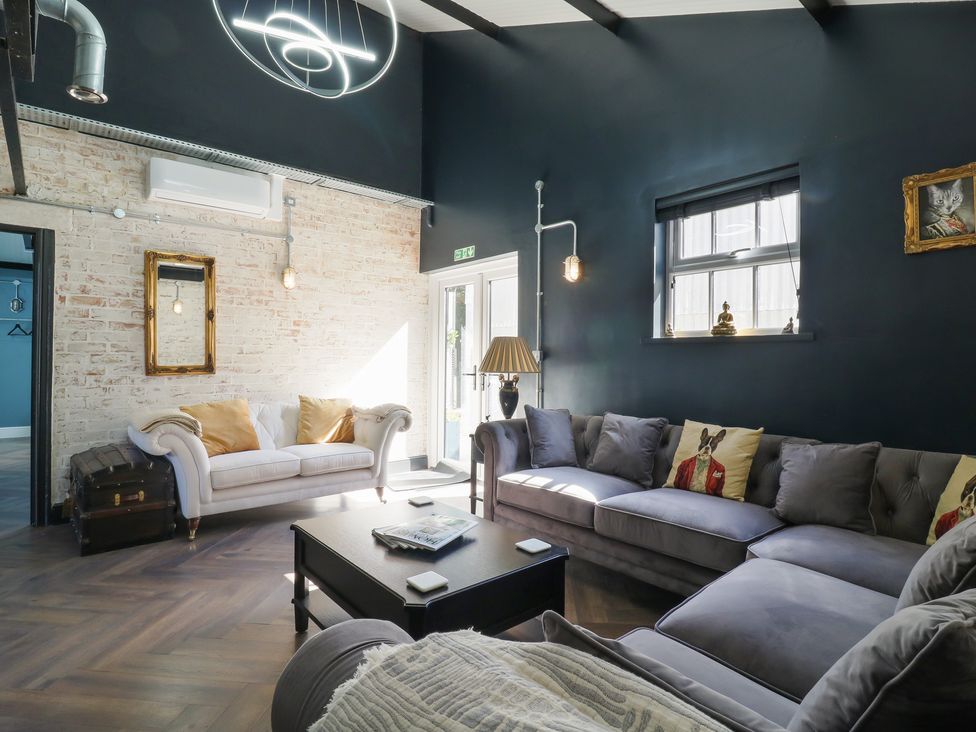 A living room with a sofa and coffee table at The Old Workshop in Wormshill near Harrietsham