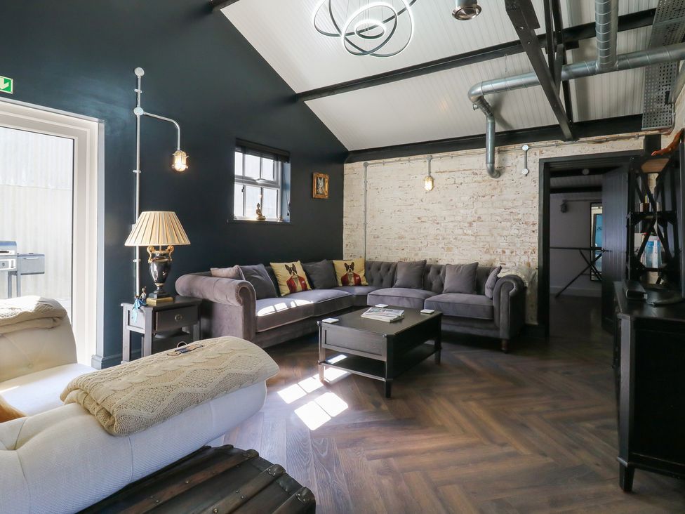 A living room with sofa and coffee table at The Old Workshop in Wormshill near Harrietsham