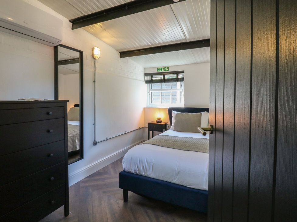 A bedroom with a bed and chest of drawers at The Old Workshop in Wormshill near Harrietsham