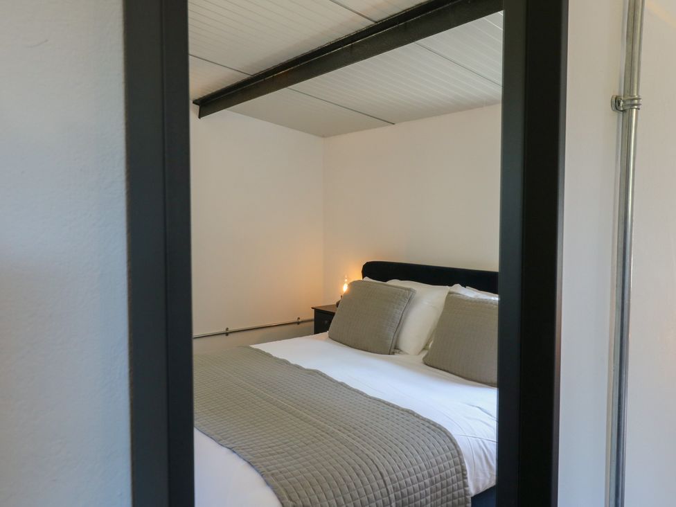 A bedroom with a bed and bedside table at The Old Workshop in Wormshill near Harrietsham