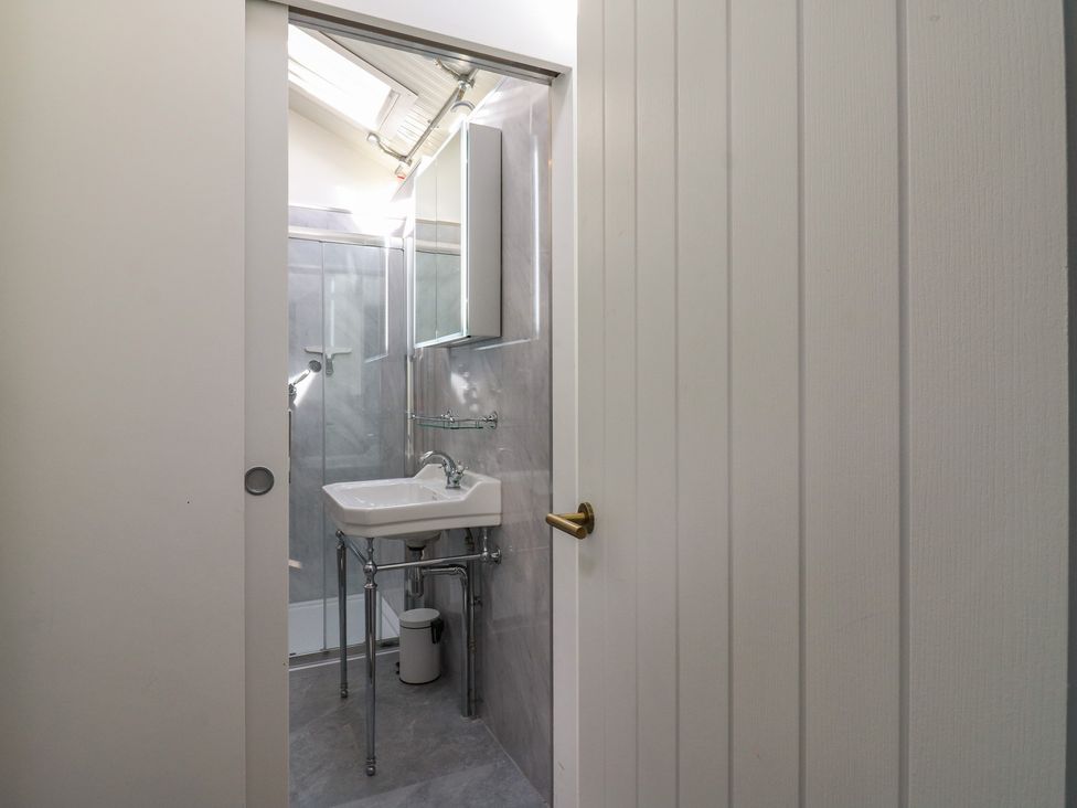 A bathroom with a sink and shower at The Old Workshop in Wormshill near Harrietsham
