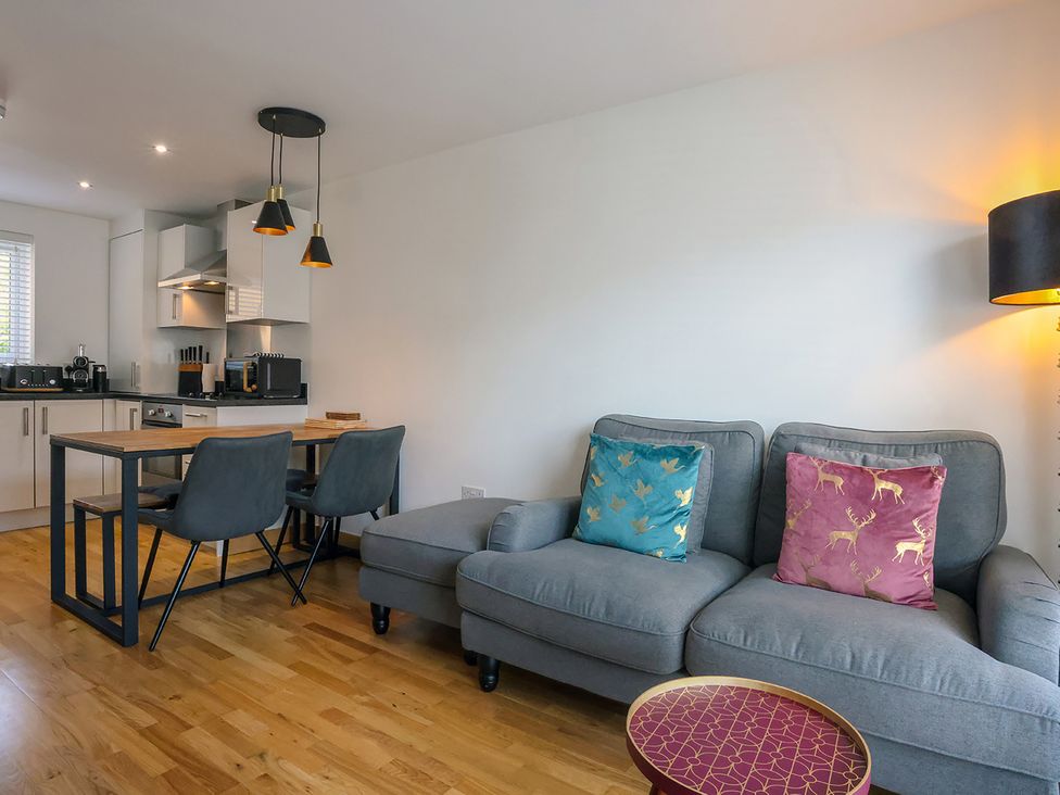 A living room with a sofa and dining table at Whitstable Bay Getaway in Whitstable
