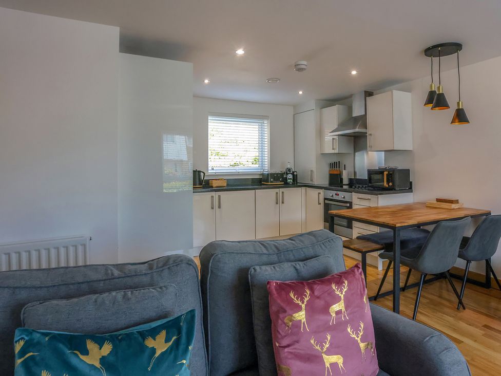 A kitchen with a dining table and a sofa at Whitstable Bay Getaway in Whitstable