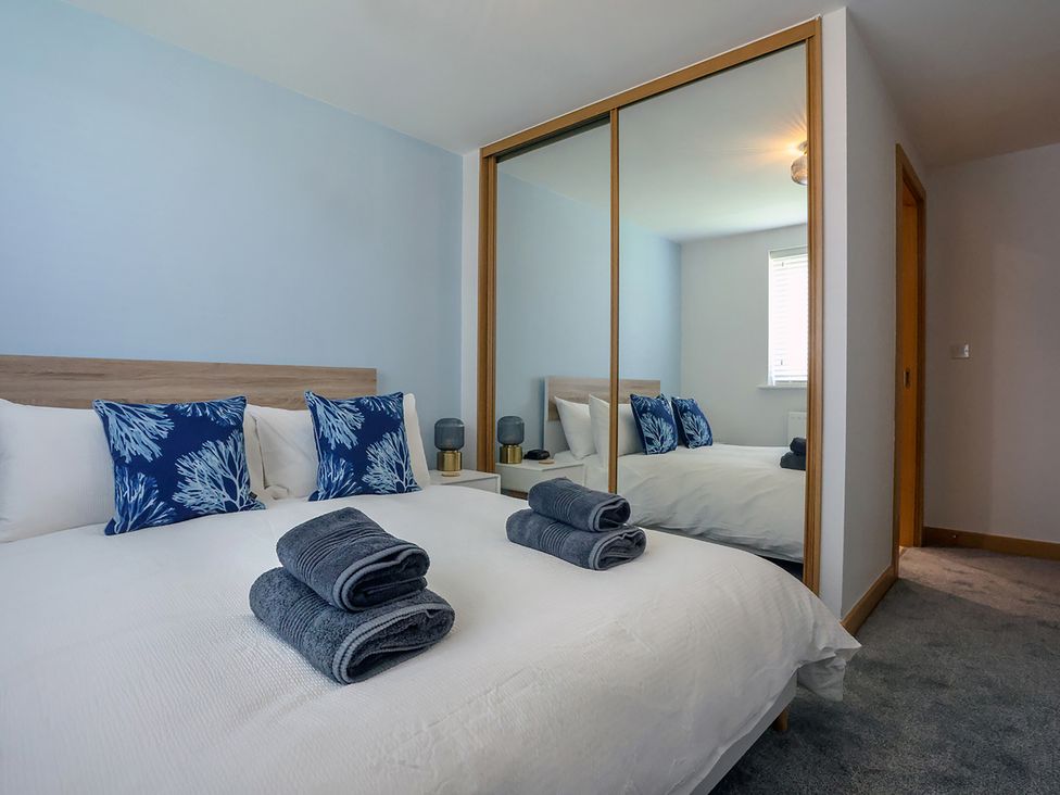 A bedroom with a bed and pillows at Whitstable Bay Getaway in Whitstable