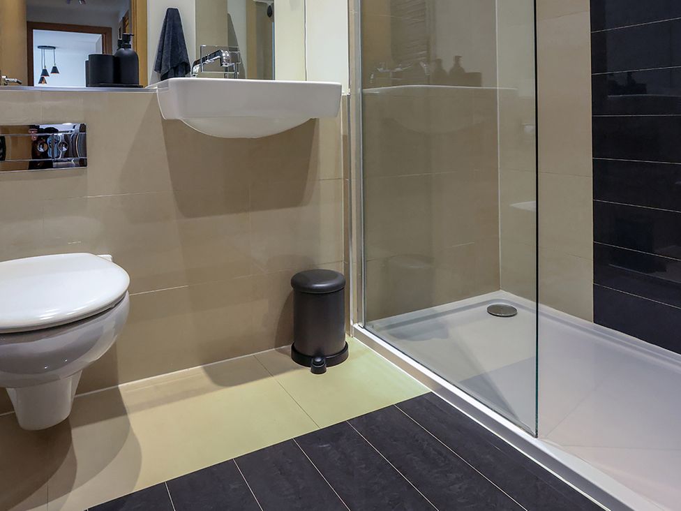 A bathroom with a toilet and shower at Whitstable Bay Getaway in Whitstable
