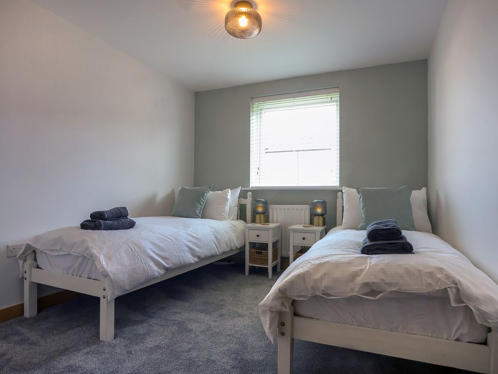 A bedroom with two beds and nightstands at Whitstable Bay Getaway in Whitstable