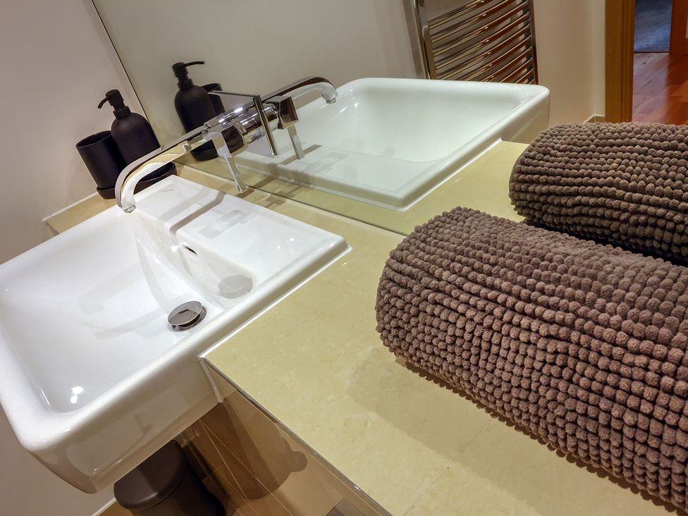 A bathroom with sinks and towels at Whitstable Bay Getaway in Whitstable