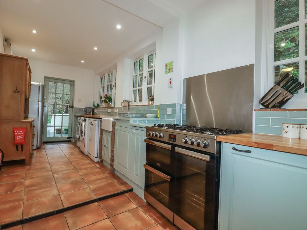 A kitchen with appliances and a door to the outdoors at Lost In The Woods Lodge near Bodmin