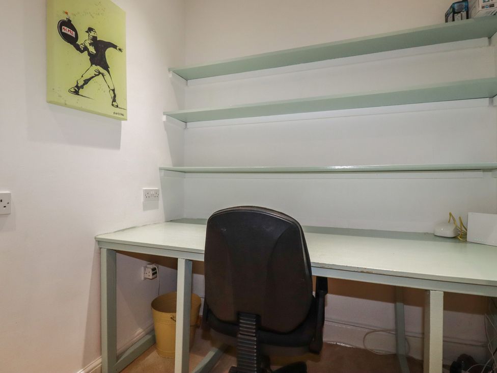An office with a desk and a chair at Lost In The Woods Lodge near Bodmin
