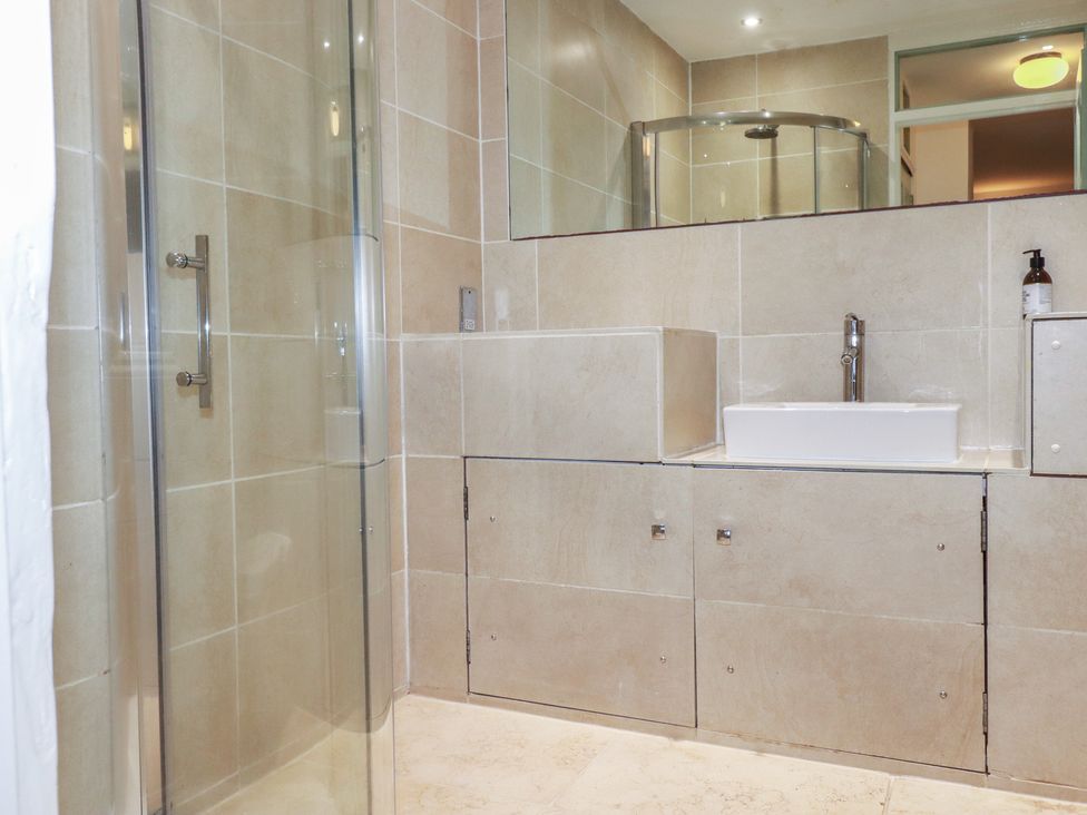 A bathroom with a shower and a sink at Lost In The Woods Lodge near Bodmin