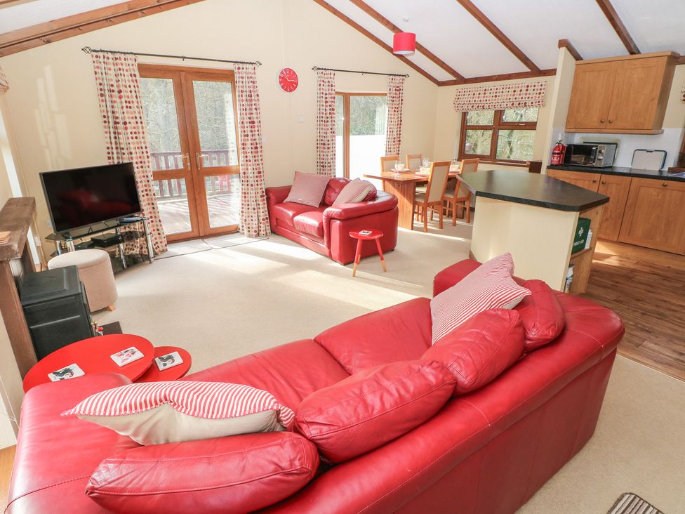 A living room with a sofa and television at Riverside Lodge 3 