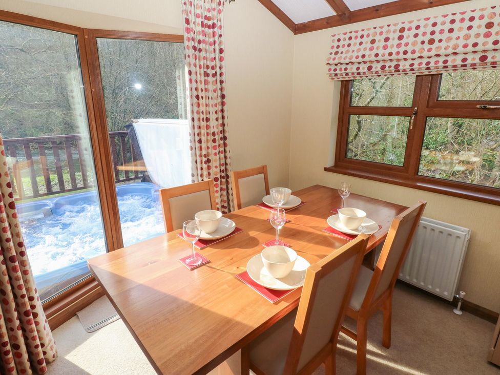A dining room with a table set for dining at Riverside Lodge 3