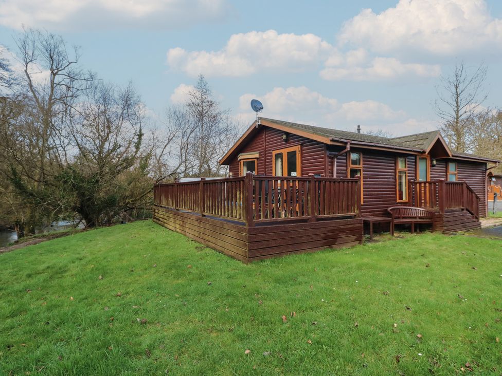 A lodge with decking and satellite dish at Riverside Lodge 3 