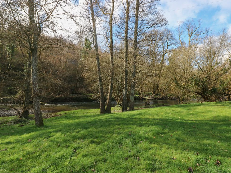 A landscape with trees and a river at Riverside Lodge 3