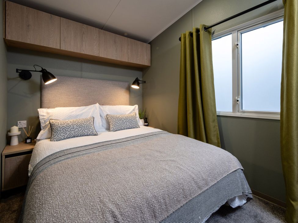 A bedroom with a bed and bedside table at Arlington 40 x 14 Two Bed