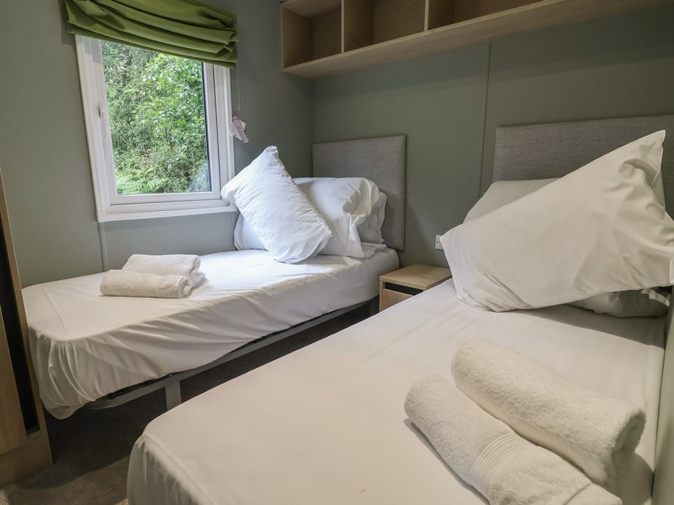 A bedroom with two beds and a window at The Pines 2 Bedrooms in Delamere