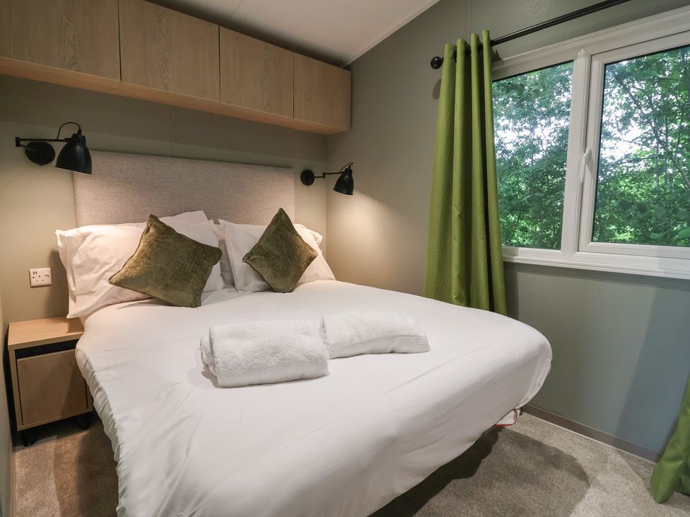 A bedroom with a bed and pillows at The Pines 2 Bedrooms in Delamere