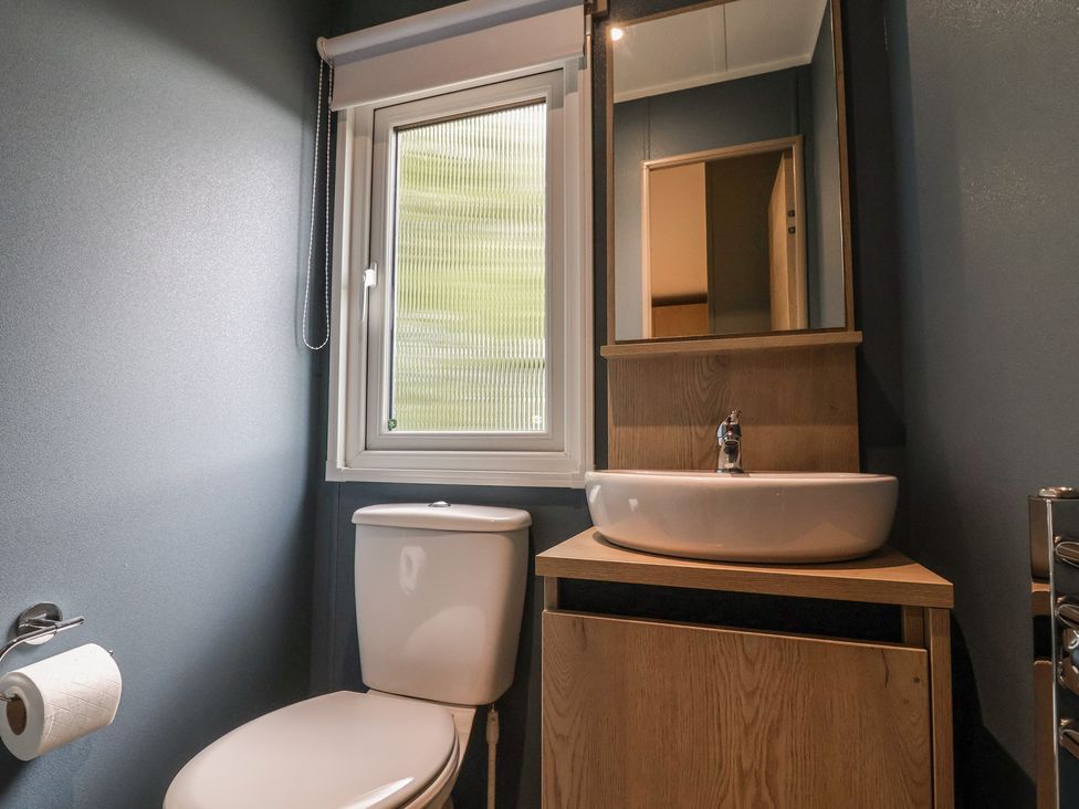 A bathroom with a toilet and sink at The Pines 2 Bedrooms in Delamere
