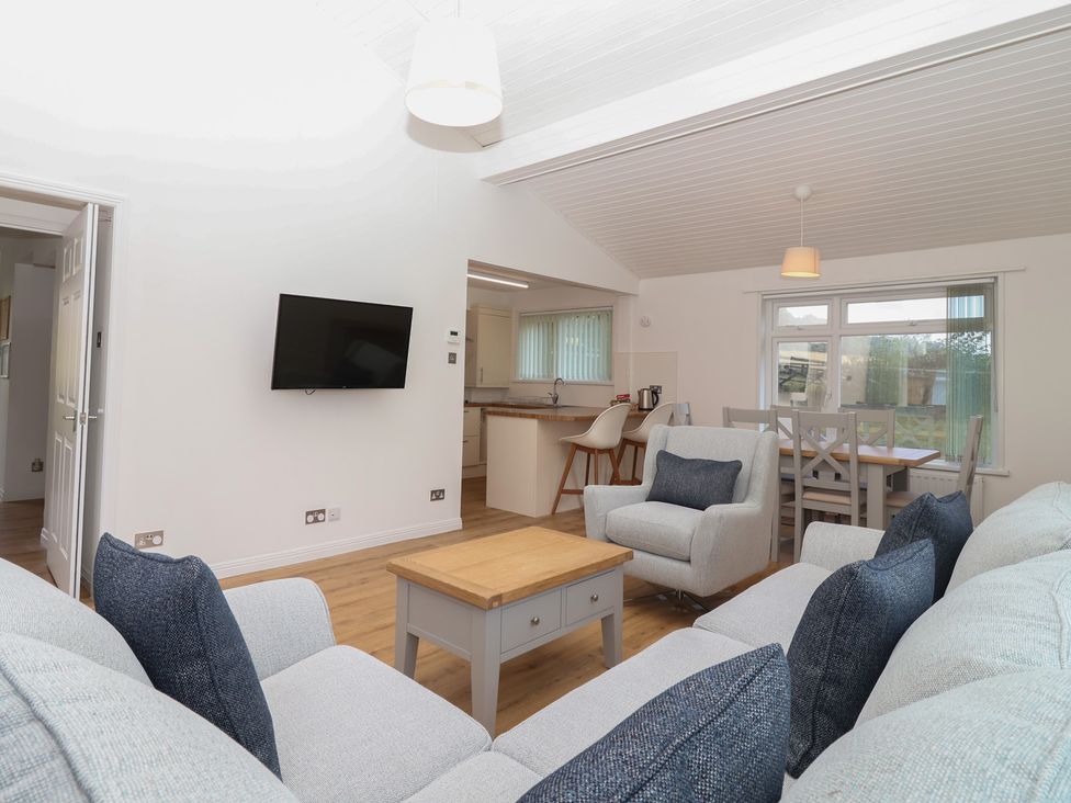 A living room with a sofa and coffee table at Harcombe House Bungalow 25 in Chudleigh