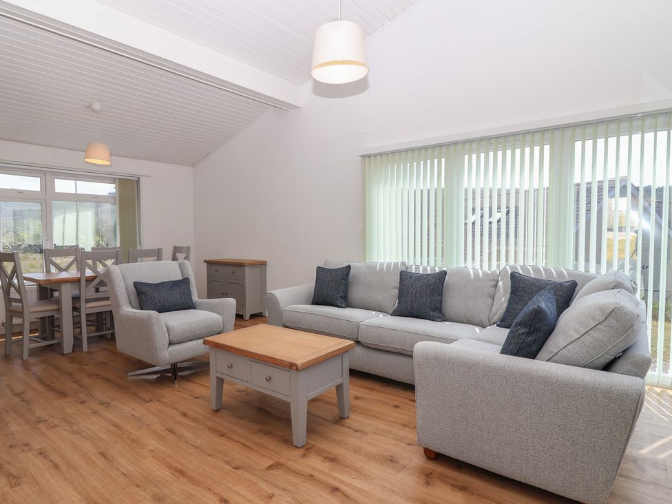 A living room with a sofa and armchair at Harcombe House Bungalow 25 in Chudleigh